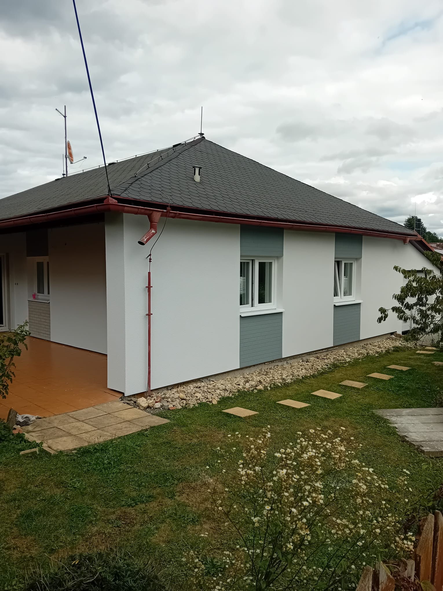 Dům s moderní bílo-šedou fasádou po rekonstrukci